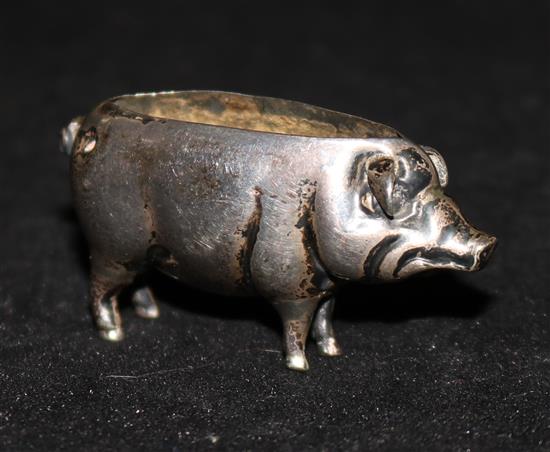 A silver pig pin cushion, Birmingham 1908, Spurrier & Co (cushion deficient).